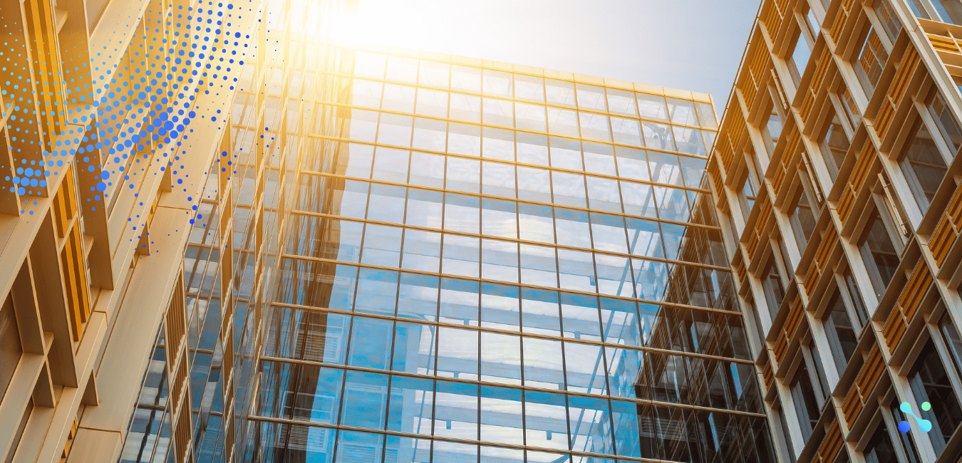 Modern glass office building reflecting sunlight, symbolizing the intersection of traditional banking and fintech innovation.